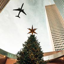 Airplane flying over Christmas tree