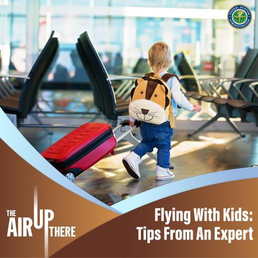 Toddler walking through an airport pulling a suitcase