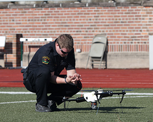A police officer examines a law enforcement drone